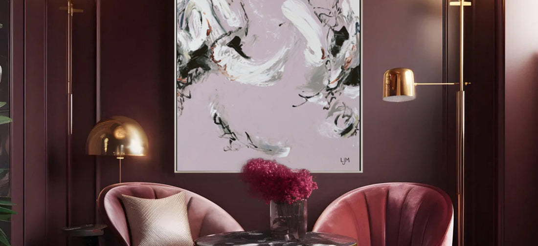 A sophisticated lounge setting with rich, dark walls showcases a bold abstract painting by Lee J Morgan Art in swirling black, white, and muted colors