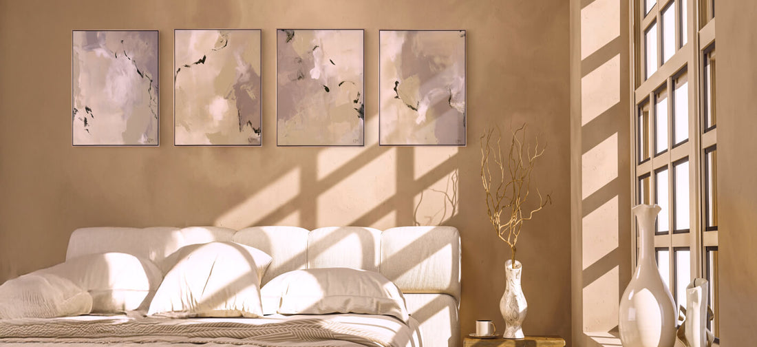 A serene, sunlit bedroom featuring a series of four abstract paintings in soft, neutral tones by Lee J Morgan Art on a warm beige wall.