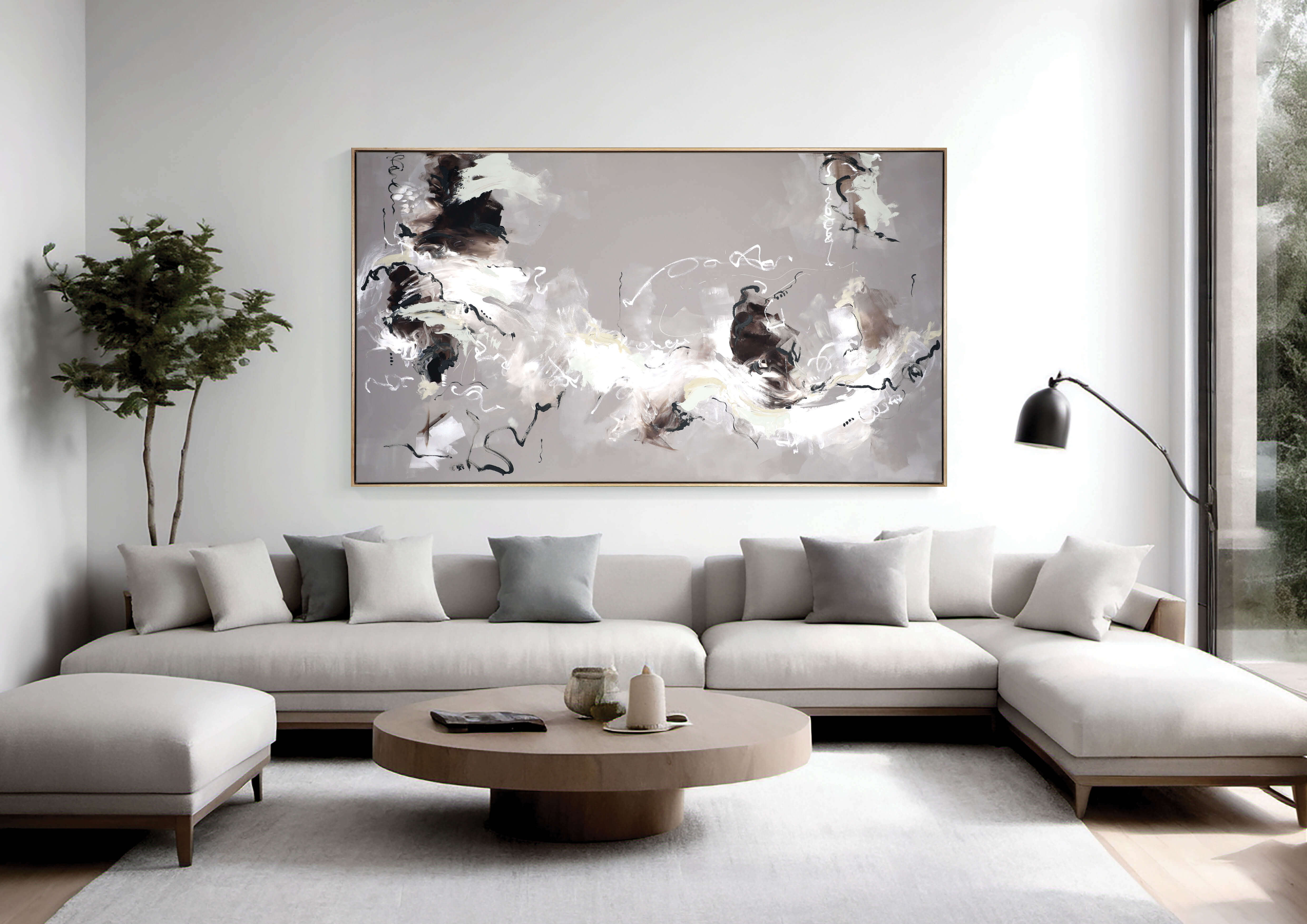 A large, neutral abstract painting by Lee J Morgan displayed on a living room wall
